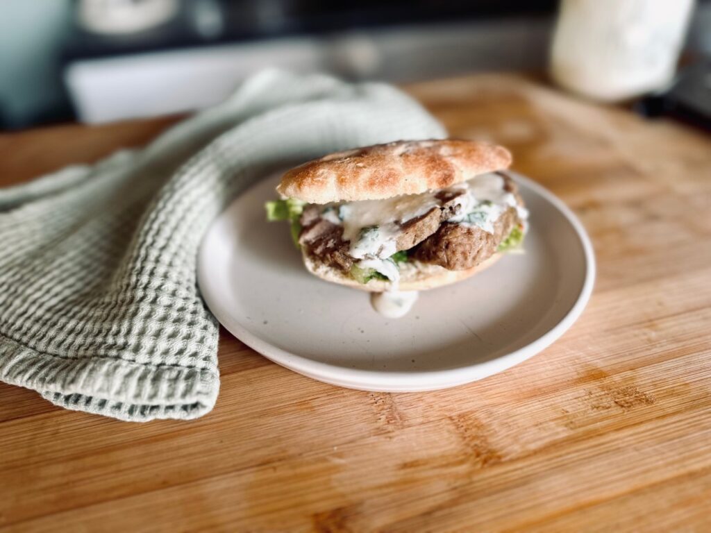 A homemade pitta, filled with lamb, and yoghurt dressing