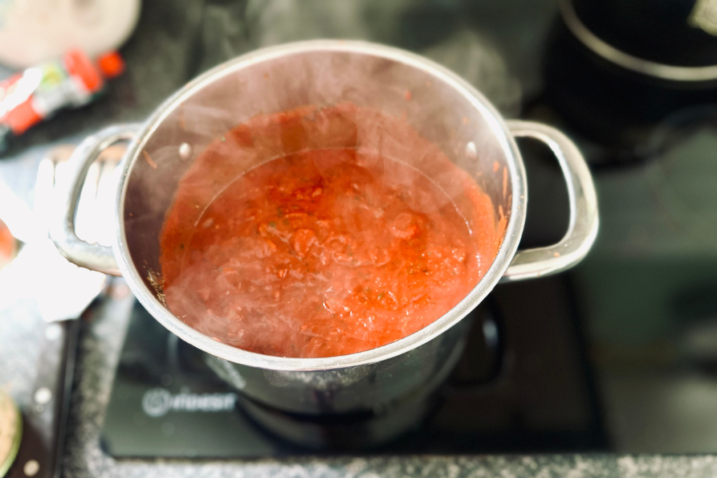 Finished sauce bubbling in a saucepan