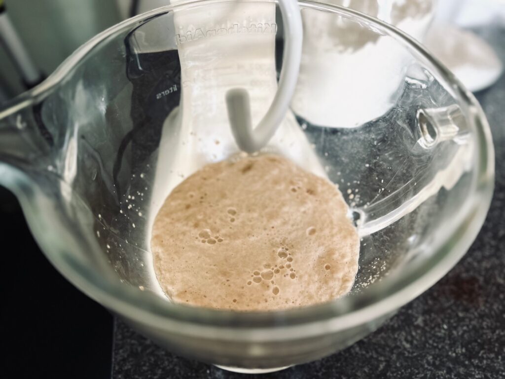 A mixing bowl containing blooming yeast