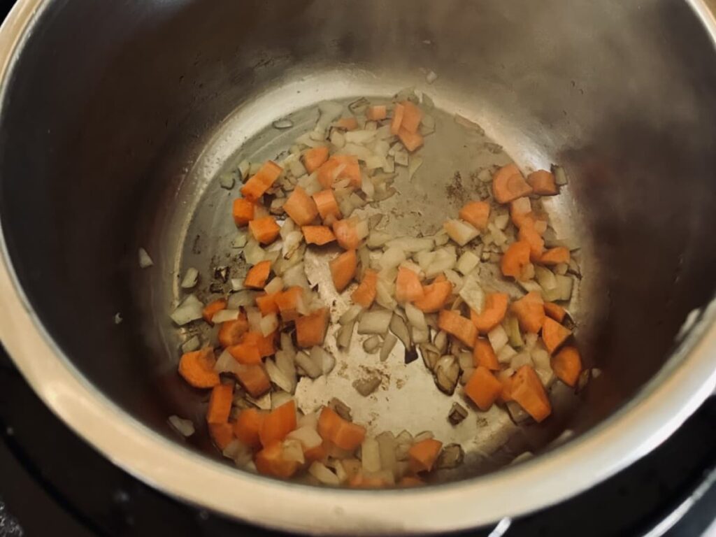 Carrots and onions sauteing in an instant pot