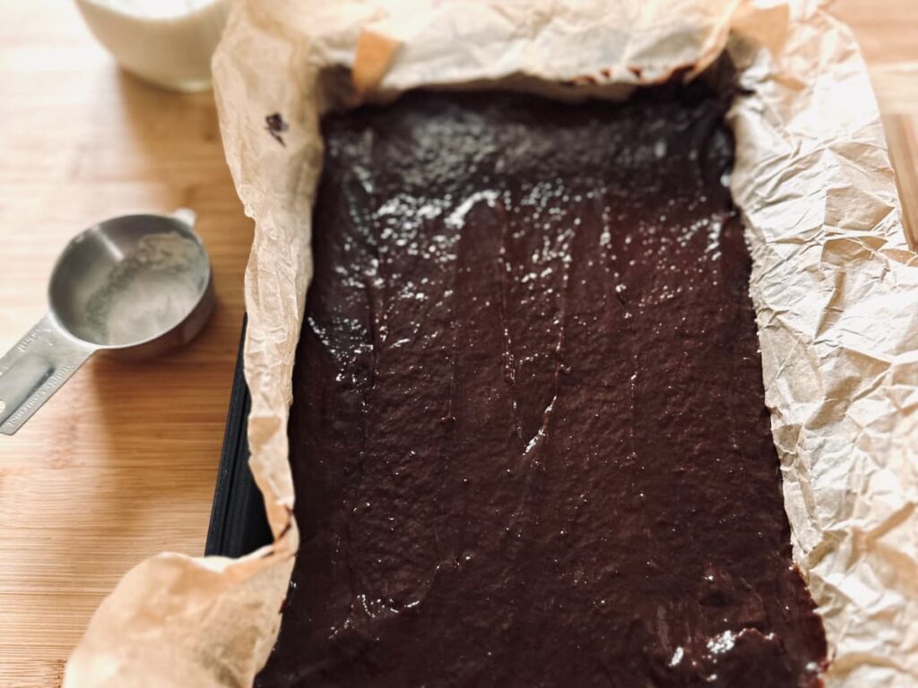 Sourdough brownie batter in a parchment lined tray