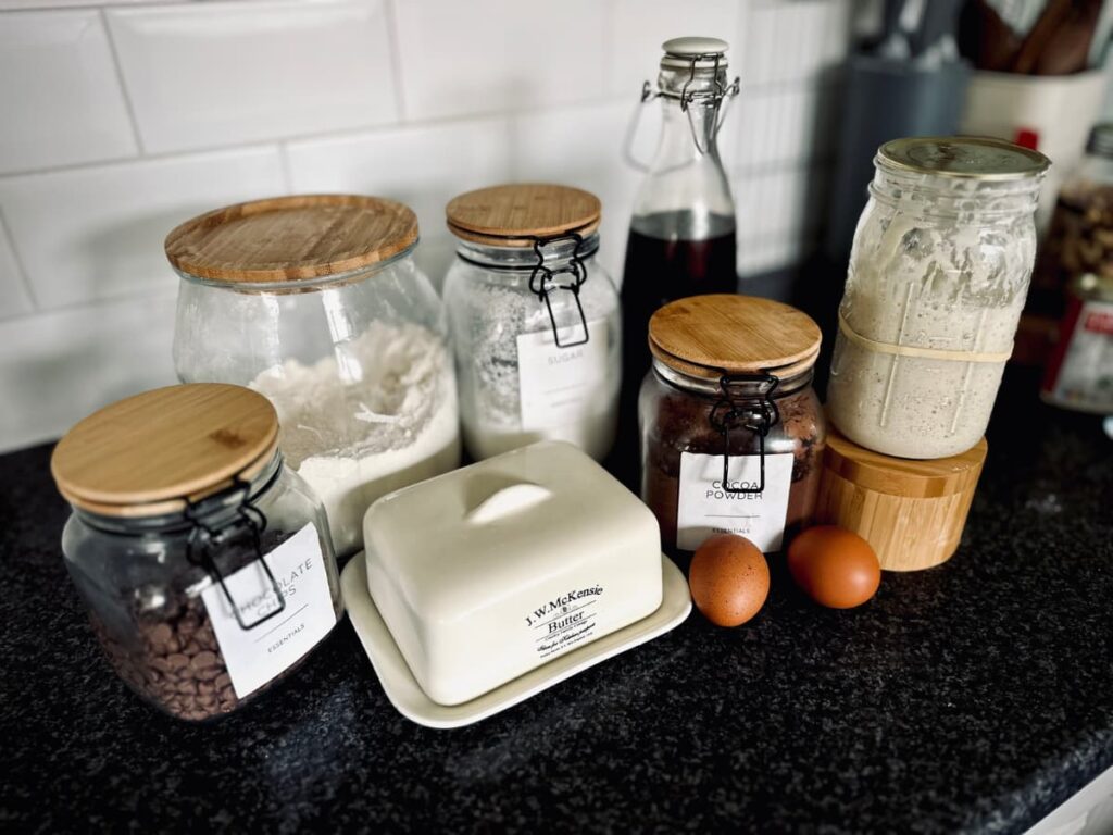A collection of jars and other ingredients to make sourdough brownies