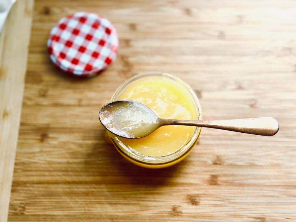 A jar of Lemon Curd on a board