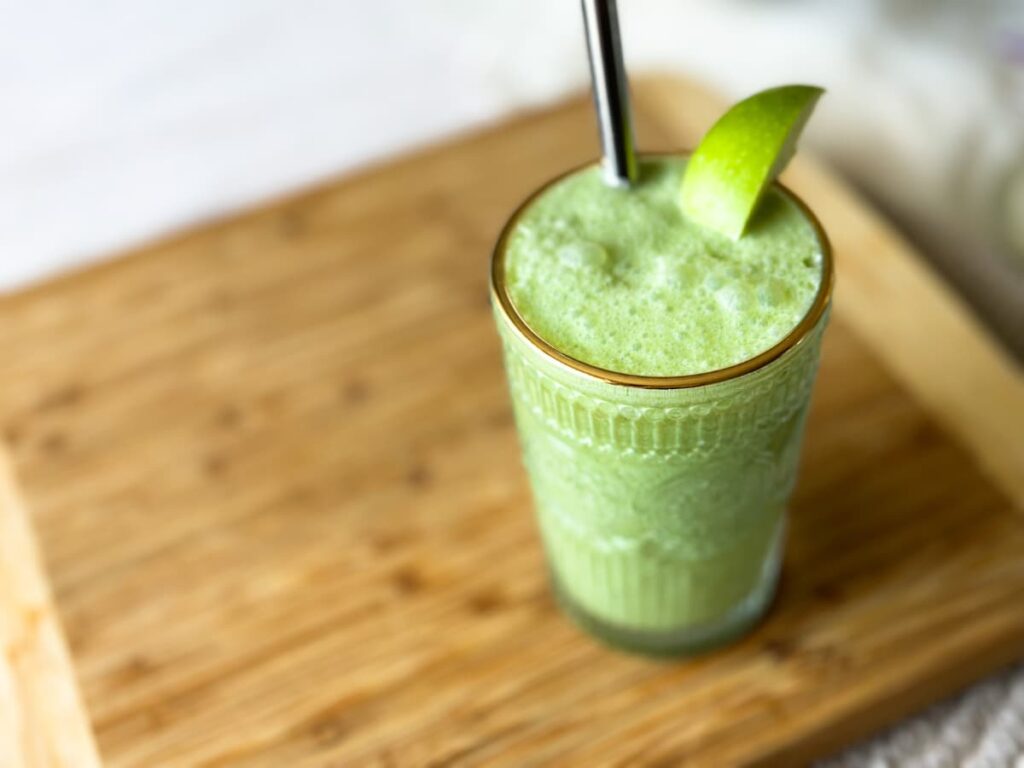 A glass of green fruit smoothie without banana