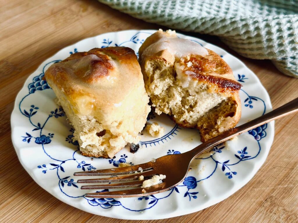 A plate of sourdough Lemon rolls half eaten, with a fork on the plate