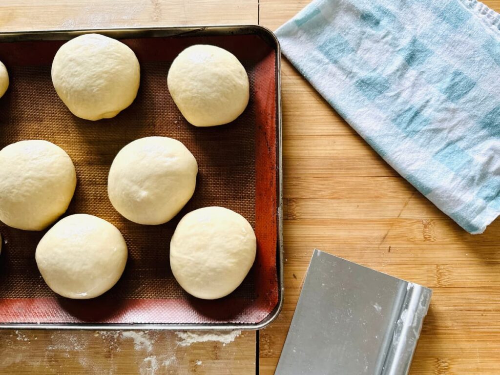 Risen buns ready to bake