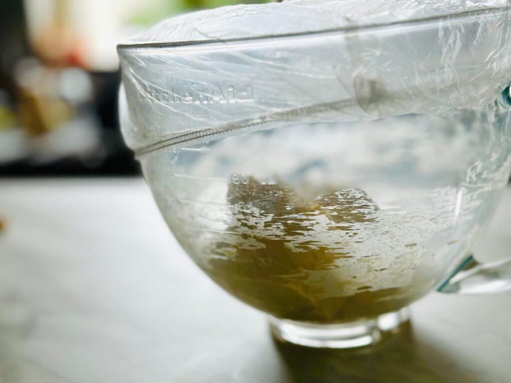 A covered bowl of Easy pitta bread dough