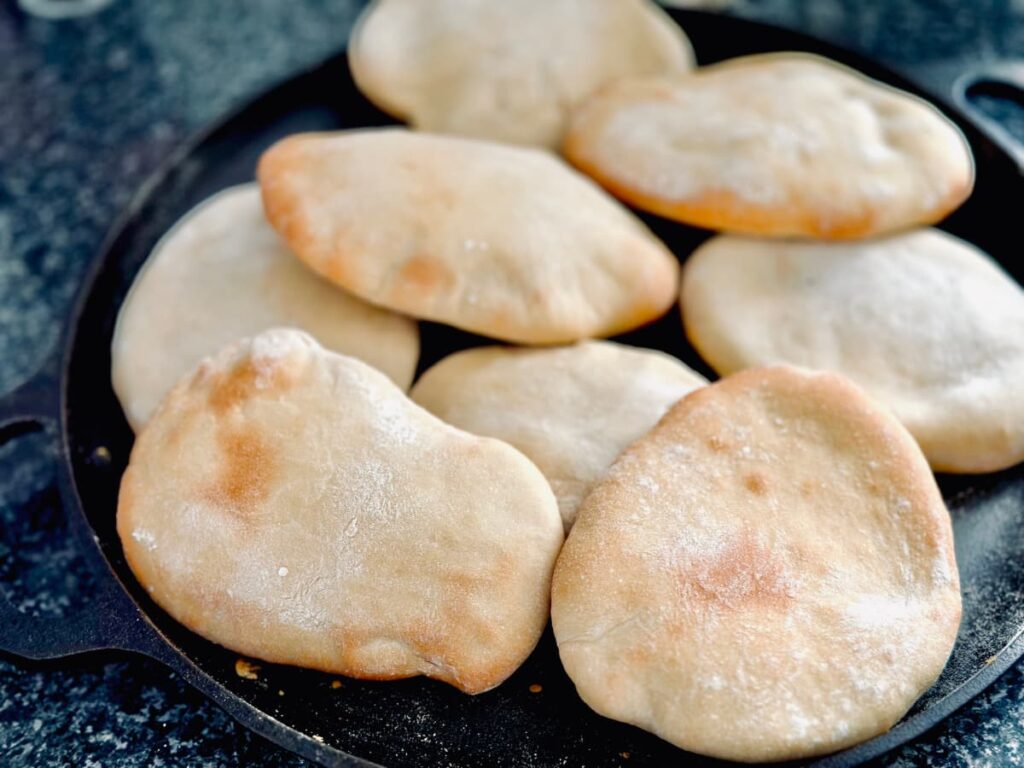 Easy Homemade Pitta breads piled on a cast iron dish