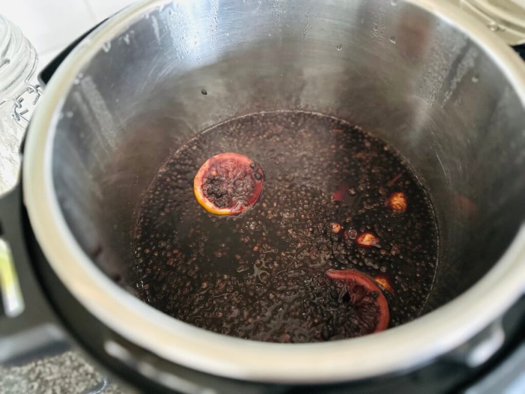 Simple Elderberry Syrup bubbling in an instant pot