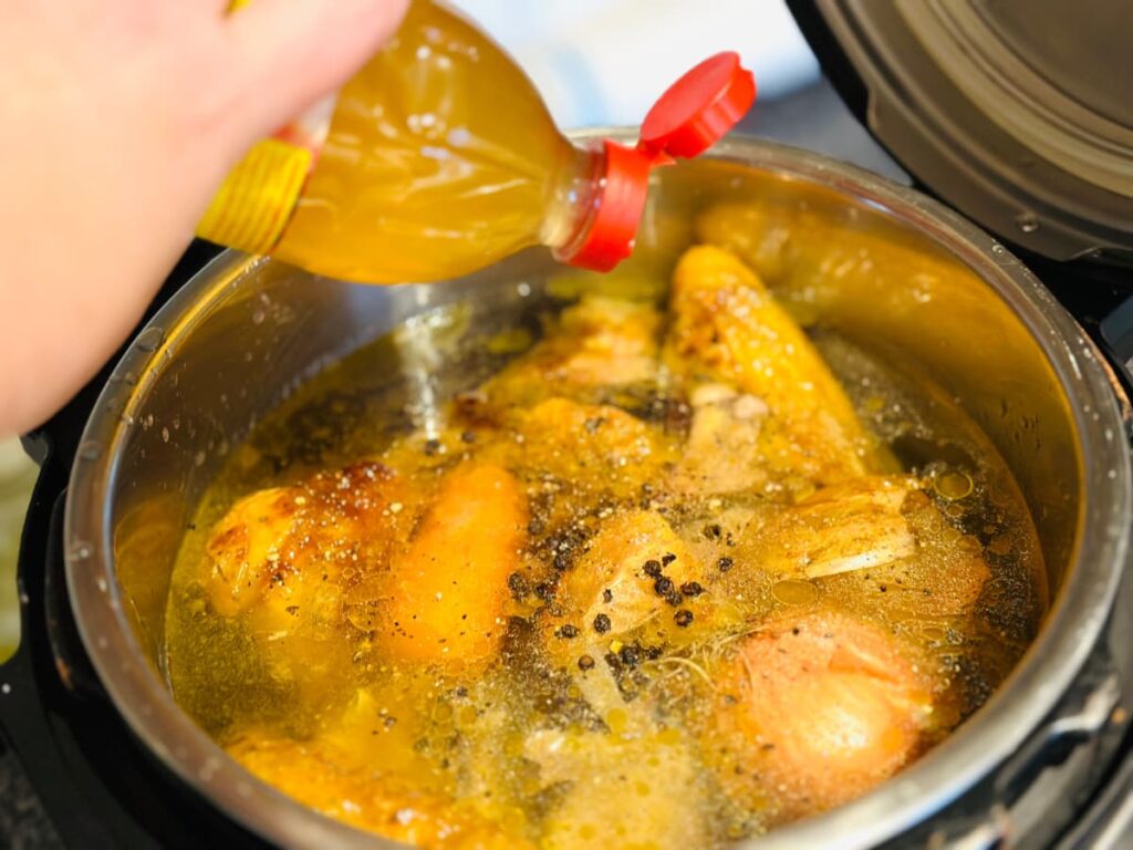 An Instant Pot full of chicken bones and veg ready to make homemade Chicken broth