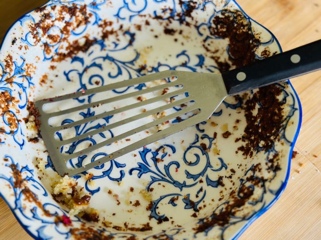 An empty pie dish with a serving spatula resting on