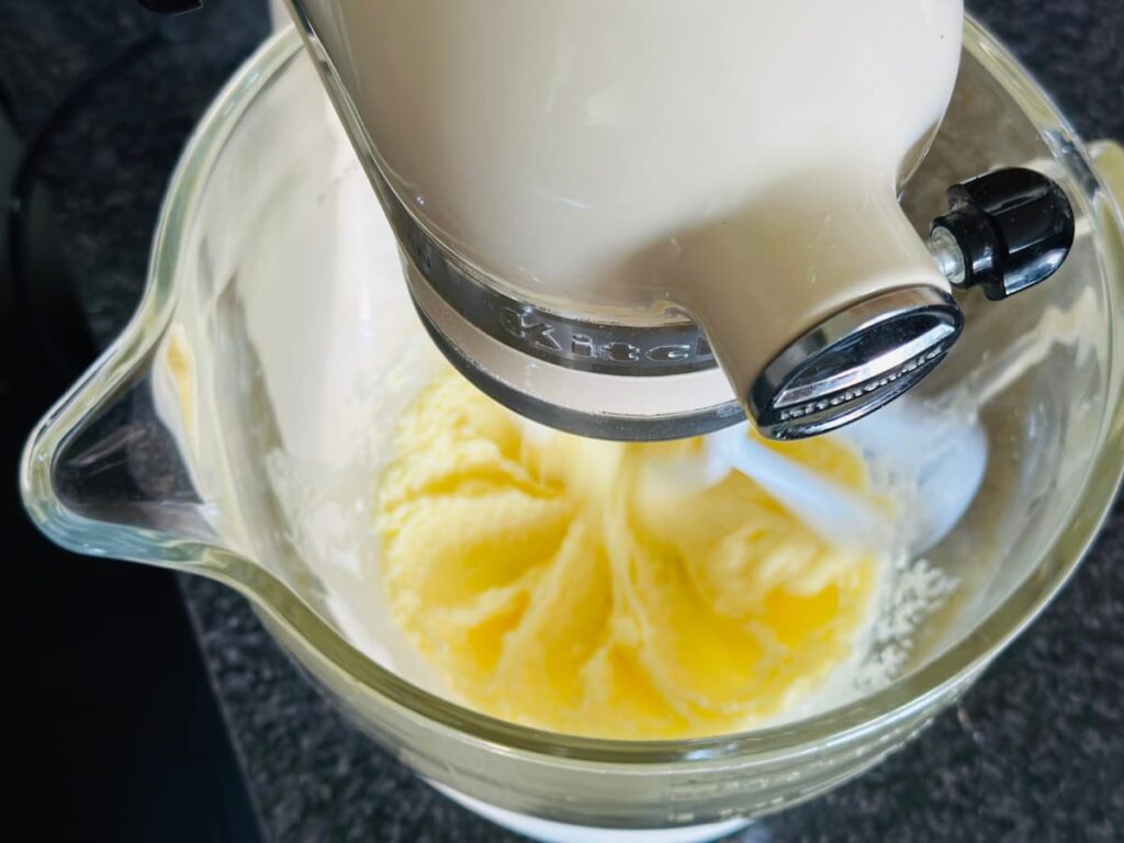 A stand mixer creaming butter and sugar
