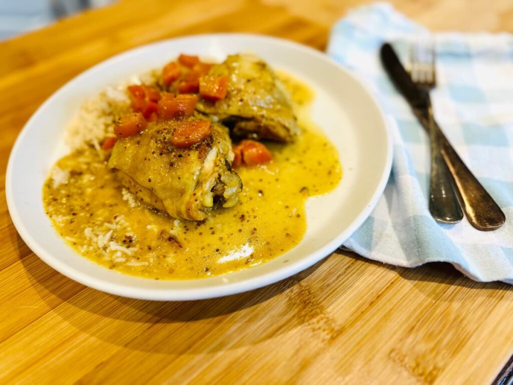 A plate of Maple Mustard chicken with cutlery on a checked napkin
