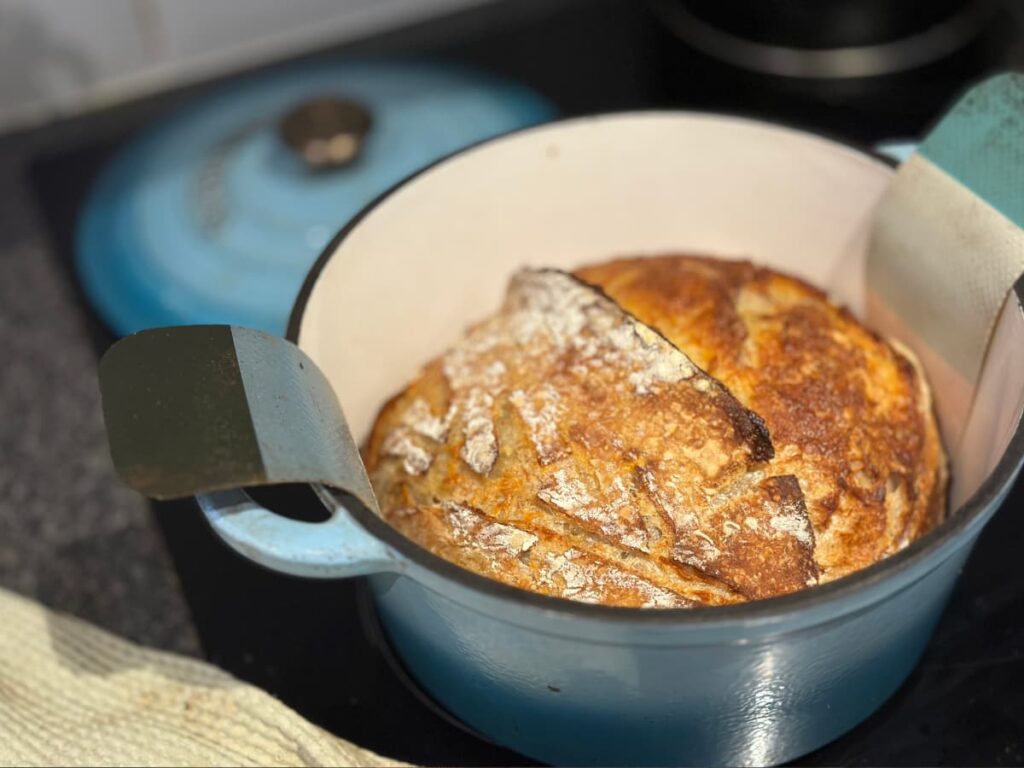 cooked sourdough bread in a dutch oven