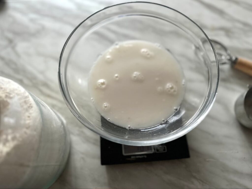 Milky liquid in a bowl on digital scales