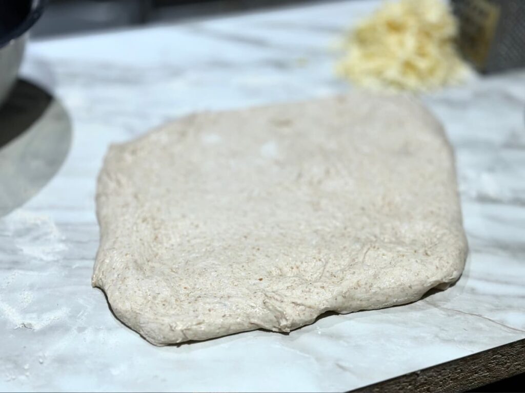 Flat rectangle of dough on a floured work surface
