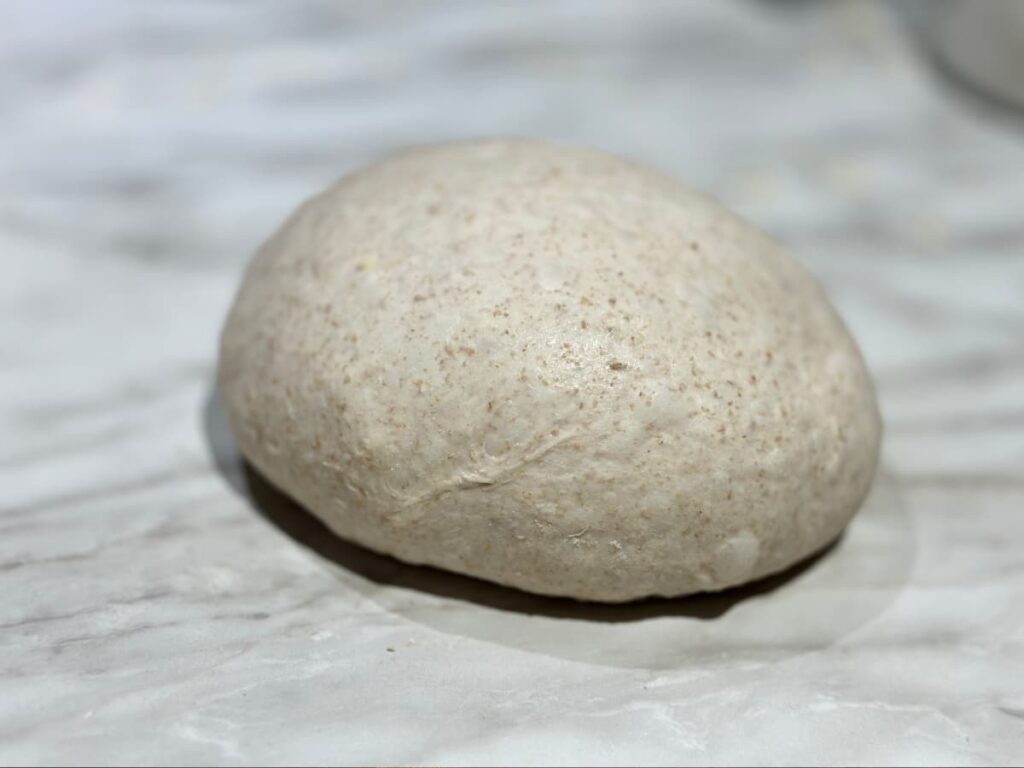 Shaped ball of dough on a floured worksurface